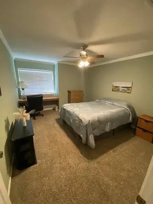 a bedroom with a bed and a desk and a window at St Annas House in Squaw Valley