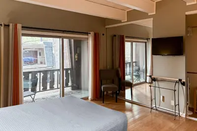 a bedroom with a bed and a view of a balcony at Incline Village Creekside Retreat in Incline Village
