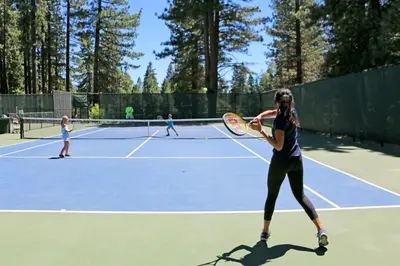 a group of people playing tennis on a tennis court at Incline Village Creekside Retreat in Incline Village