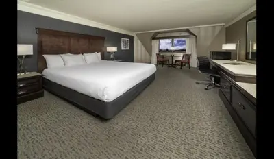 a hotel room with a large bed and a desk at Carson Valley Inn in Minden