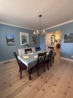 a dining room with a table and chairs and blue walls at The Firehouse Inn-Cottage in Mariposa