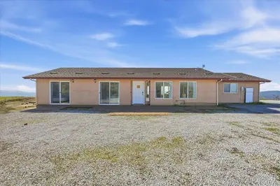 a home in a field with a large yard at Incredible View Near Yosemite, Spacious 4BR House! in Coarsegold
