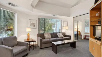 a living room with a couch and a tv at The Ridgeline by AvantStay Shared Pool Hot Tub Sauna Ski-In Access Village Walk in Olympic Valley