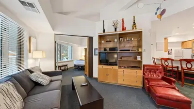 a living room with a couch and a table at The Ridgeline by AvantStay Shared Pool Hot Tub Sauna Ski-In Access Village Walk in Olympic Valley