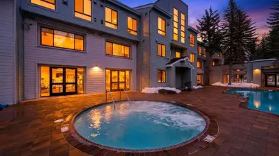 a large house with a large swimming pool in front of it at The Ridgeline by AvantStay Shared Pool Hot Tub Sauna Ski-In Access Village Walk in Olympic Valley