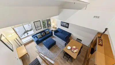 an overhead view of a living room with blue furniture at The Traverse by AvantStay Ski-InSki-Out Condo • Pool Hot Tub Access • Steps to KT-22 in Olympic Valley
