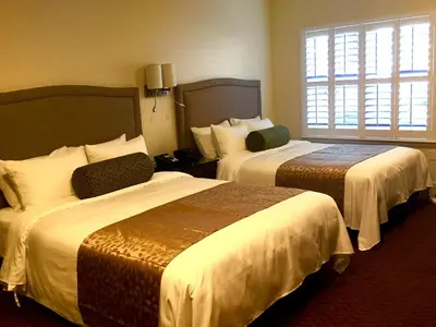 a hotel room with two beds and a window at Rest, a boutique hotel in Plymouth