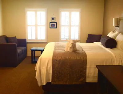 a hotel room with a teddy bear sitting on a bed at Rest, a boutique hotel in Plymouth
