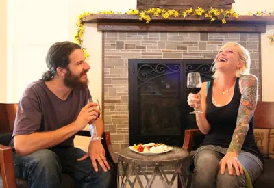 a man and a woman sitting in chairs with wine glasses at Rest, a boutique hotel in Plymouth