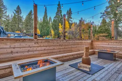 a patio with a fire pit on a wooden deck at Basecamp Tahoe City in Tahoe City