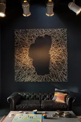 a living room with a black couch and a wall with a picture at Basecamp Tahoe City in Tahoe City