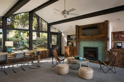 a living room with a table and a fireplace at Basecamp Tahoe City in Tahoe City