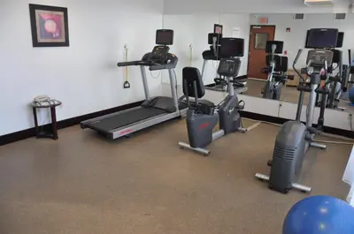 a gym with several exercise bikes and a treadmill at Holiday Inn Express & Suites Jackson by IHG in Jackson
