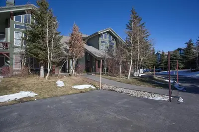 a house with a driveway in front of a building at Snowcreek #881 - Phase V in Mammoth Lakes