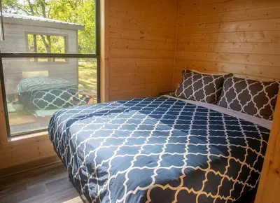 a bedroom with a bed in a room with a window at Sierra Meadows in Ahwahnee