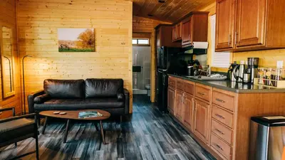 a living room with a leather couch in a kitchen at Sierra Meadows in Ahwahnee