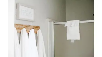 a bathroom with a shower curtain and a mirror at Lazy Z Resort in Twain Harte