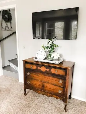 a wooden dresser with a plant on top of it at Lazy Z Resort in Twain Harte
