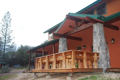 a house with a porch on the side of it at Sierra Trails Inn in Mariposa