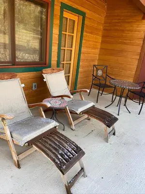 a group of chairs and tables on a porch at Sierra Trails Inn in Mariposa