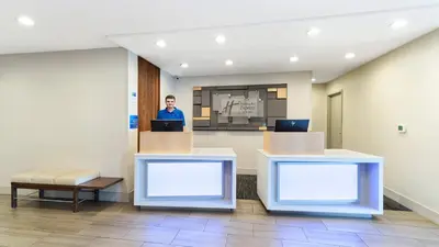 a man is standing in a waiting room at Holiday Inn Express & Suites Dinuba West by IHG in Dinuba