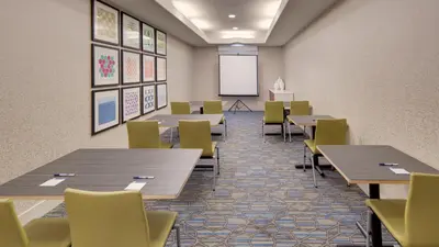 a classroom with tables and chairs and a whiteboard at Holiday Inn Express & Suites Dinuba West by IHG in Dinuba
