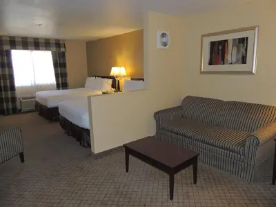 a hotel room with a bed and a couch at Holiday Inn Express Fallon by IHG in Fallon