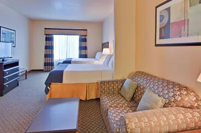 a hotel room with a bed and a couch at Holiday Inn Express Delano Highway 99 by IHG in Delano