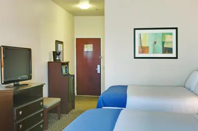 a hotel room with a bed and a tv at Holiday Inn Express Delano Highway 99 by IHG in Delano