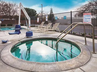 a small swimming pool with a slide in it at La Quinta by Wyndham Fresno Northwest in Fresno