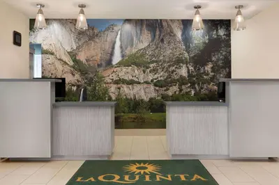 a lobby with a waterfall mural on the wall at La Quinta by Wyndham Fresno Northwest in Fresno