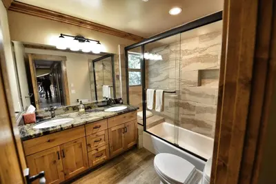a bathroom with two sinks and a shower at Mountain Shadows Retreat in Foresthill