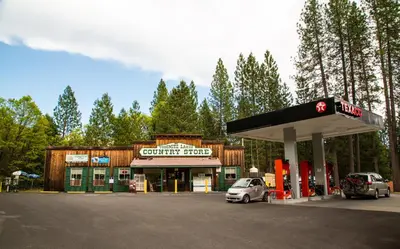 a gas station with a car parked in front of it at Yosemite Lakes Wheelchair Accessible Meadow Yurt 16 in Harden Flat