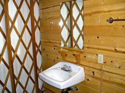 a bathroom with a sink and a mirror at Yosemite Lakes River Yurt 21 in Harden Flat