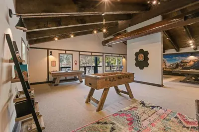 a room with a ping pong table in the middle at Yosemite Lakes Bunkhouses in Harden Flat