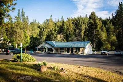 a building on the side of a road with trees at Yosemite Lakes Cabin 39 in Harden Flat