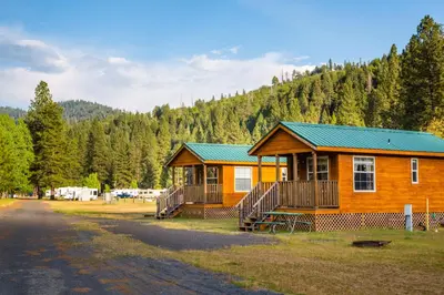 a large wooden cabin with a green roof at Yosemite Lakes Cabin 39 in Harden Flat