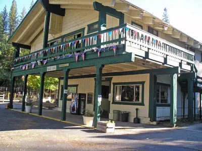 a building with a balcony with flags on it at Yosemite Lakes Cabin 39 in Harden Flat