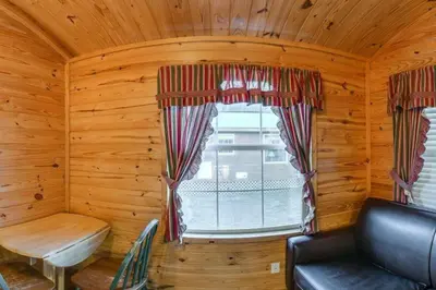 a room with a window in a log cabin at Yosemite Lakes Cabin & Cottages in Harden Flat