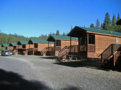 a row of lodges with a car parked in front at Yosemite Lakes Wheelchair Accessible Cabin 46 in Harden Flat