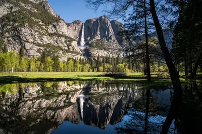 a reflection of a mountain in a lake at Holiday Inn Express & Suites Oakhurst-Yosemite Park Area by IHG in Oakhurst