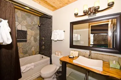 a bathroom with a tub and a toilet and a sink at Village Treehouse #2 in Mammoth Lakes