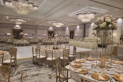 a banquet hall with tables and chairs and chandeliers at DoubleTree by Hilton Modesto in Modesto