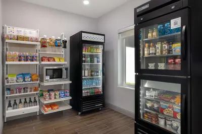 a refrigerator with its door open in a kitchen at Spark By Hilton Santa Nella in Santa Nella Village