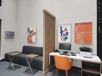 a office with a desk and a couch and a computer at Holiday Inn Express & Suites Lathrop by IHG in Lathrop