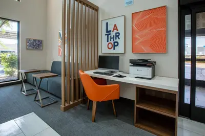 an office with a desk with a computer and a chair at Holiday Inn Express & Suites Lathrop by IHG in Lathrop