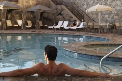 a man sitting in the pool at a hotel at Chukchansi Gold Resort & Casino in Coarsegold