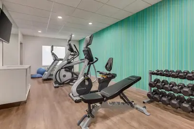 a gym with several treadmills and exercise bikes at Holiday Inn Express & Suites Merced - Yosemite Natl Pk Area by IHG in Merced
