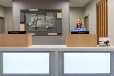 a woman standing at a podium in a room at Holiday Inn Express & Suites Merced - Yosemite Natl Pk Area by IHG in Merced