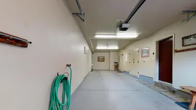 an empty hallway with a green hose on the wall at Juniper Crest 6 Apartment in Mammoth Lakes